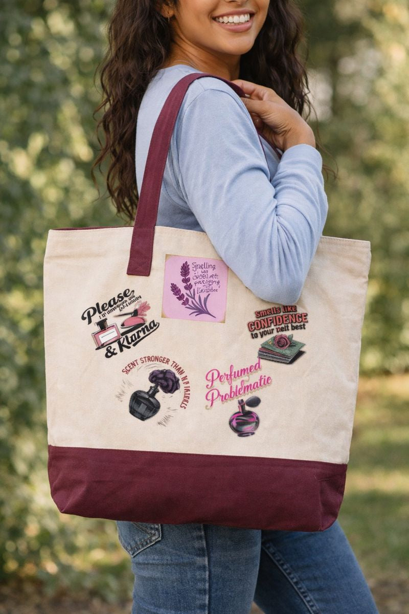 Smiling woman outdoors carrying a beige and burgundy tote bag with bold perfume-themed graphics, SkinCandyMuse fashion accessory.